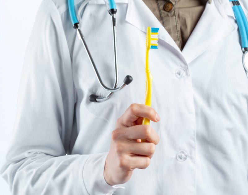 toothbrush in hands of medical dental doctor